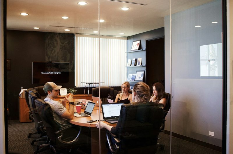 A hiring team talking around a conference table.